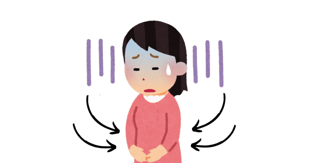 お腹に手をあてて青ざめた表情の少女