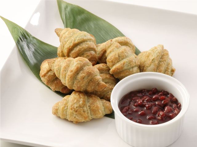 笹の葉の上に笹団子クロワッサンが大量に乗せてある写真